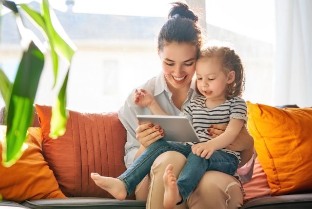 Mom and toddler reading tablet